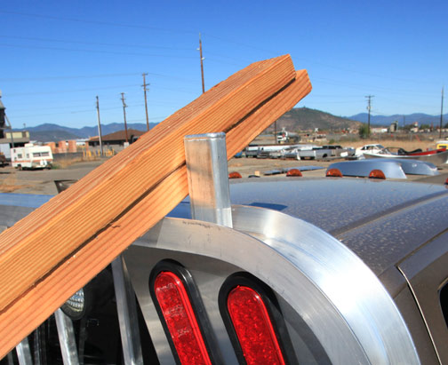 Lumber stop for aluminum truck cab guard